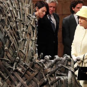 Queen Elizabeth II meets cast members of the HBO TV series Game of Thrones Lena Headey and Conleth Hill as she views some of the props including the Iron Throne on set in Belfasts Titanic Quarter on June 24 2014 in Belfast Northern Ireland