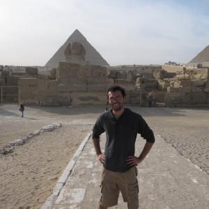 This is a picture of my in Egypt with the pyramids and the Sphinx behind me.
