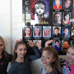 Lauren with her sisters and the cast poster for Performance Riversides Les Miserables where she played Young Eponine