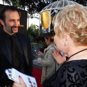 Dr Diane Howard interviewing Kevin Sizemore Woodlawn actor on red carpet at 24th Movieguide Awards Gala as interviewer journalist 2016