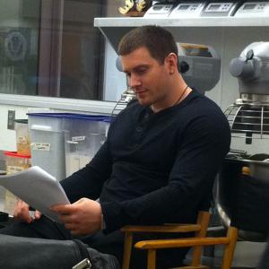 Kyle English studying his lines on the set of 