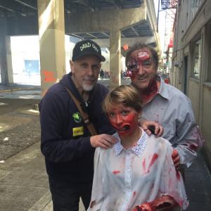 Writer Randall Jahnson left poses with Andrielle Andie Sliwa center and David Sliwa Right on the set of Zombie Day Apocalypse