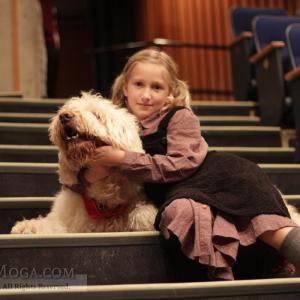 Maria Moga and her canine costar on the stage of the musical Annie