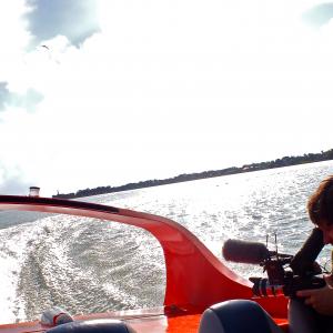 Filming the Galveston-Bolivar ferry aboard a jet boat for the movie, 