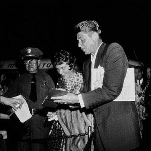 Ronald and Nancy Reagan signing autographs at the Ice Follies premiere