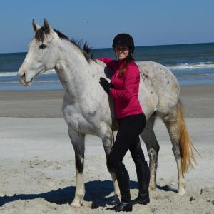 Lindsey with 'Soar' her 2015 Thoroughbred Makeover winner at the beach in Florida during a photo shoot.